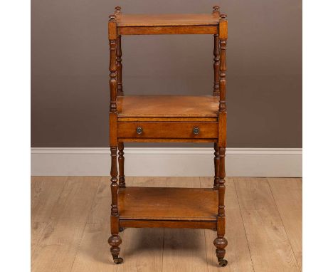 With turned supports and a frieze drawer to the central section, all standing on turned tapering feet and brass castors. 48cm