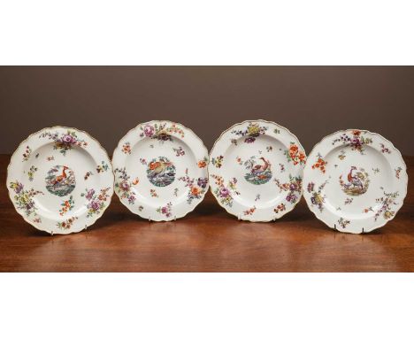 With gold anchor marks to the backs, of shaped circular form with gilt rim, painted with exotic birds and floral sprays.23.5c