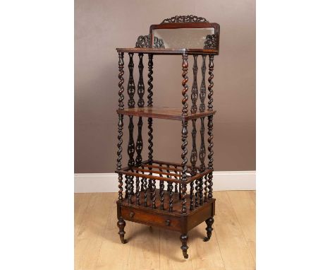The top tier with a mirror panelled back and fret-carved brackets to the sides, spiral turned supports, base drawer, and balu