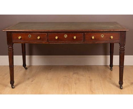 WIth a tooled green leather inset top. The frieze with three fitted drawers on one side and three dummy drawers on the other,
