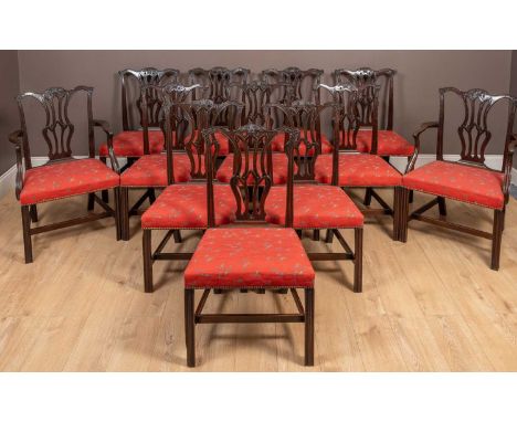 An antique set of twelve mahogany dining chairs with two carvers in the Chippendale style with baluster-shaped pierced splats