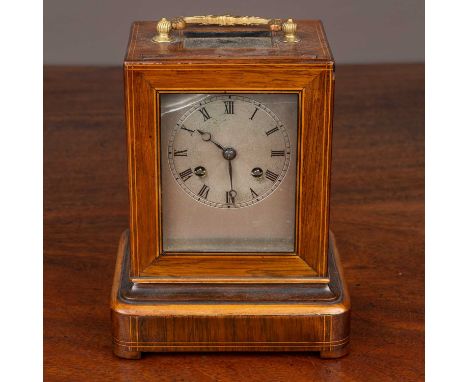 A late 19th century inlaid rosewood cased mantle clock, the silvered dial with roman numerals, the French movement with silk 