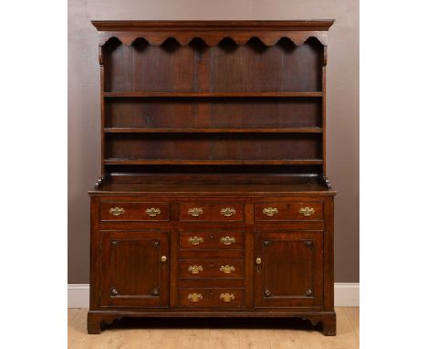 With a three-shelf plate rack above. The base with three drawers over three fauz drawers and two panelled cupboard doors, all