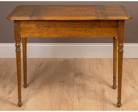 The top with a hinged central panel opening to reveal letter racks. The frieze folding out to provide a writing surface and a