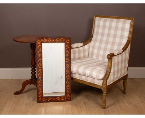 Comprising of a French style open armchair with a carved wooden frame, and beige and cream upholstery, on turned reeded taper