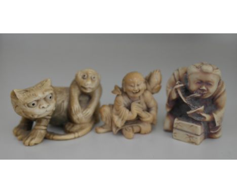 A Meiji period ivory Netsuke of a tiger and monkey; together with a later resin example