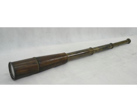 A large leather covered telescope