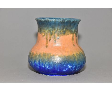 RUSKIN POTTERY, an elephant's foot shaped vase, covered in bands of green, orange and blue glazes, impressed Ruskin England 1