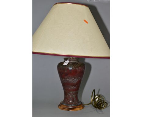 A COBRIDGE STONEWARE HIGH FIRED BALUSTER TABLE LAMP, mottled green/blue glaze over a red ground, mounted on a wooden base, he