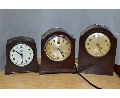 THREE BROWN BAKELITE CASED ELECTRIC MANTEL CLOCKS, comprising a Ferranti, height 17.5cm, a Genolex with date aperture, height
