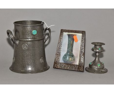 AN ARTS AND CRAFTS PEWTER TWIN HANDLED WINE COOLER, of conical form, hand hammered finish, two circular turquoise glazed cera