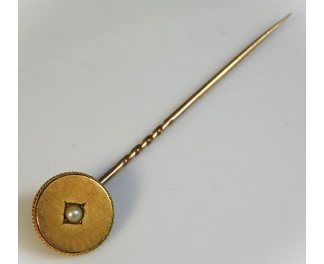A yellow metal tie pin, head set with pearl, head tests as 18ct gold, pin as 9ct gold, 2.4g total