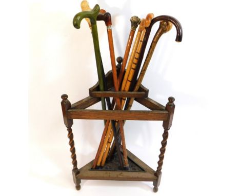 A barley twist oak stick stand with eight sticks including one with owl handles one with dog &amp; one amber style