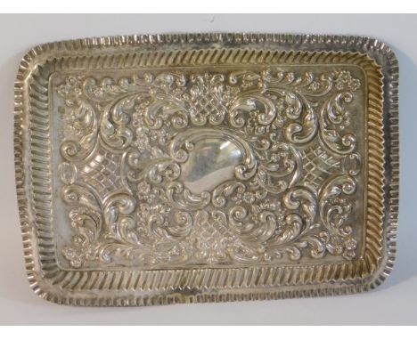 An Edwardian embossed silver tray by Robert Pringle &amp; Sons, London 1902, some misshaping, 10.75in x 7.5in, 185g