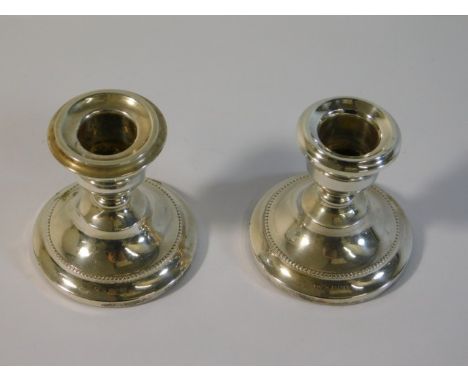 A pair of 1965 Birmingham silver candle holders by Cohen &amp; Charles, one lacking sconce, 184.9g inc. 2.75in tall