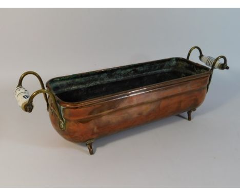 A copper trough with brass fittings &amp; porcelain handles, 17.75in wide x 5in deep x 5.5in high