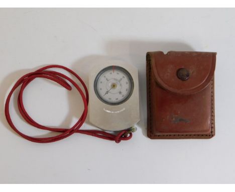 A vintage Suunto compass from Finland with leather pouch, 3in x 2in