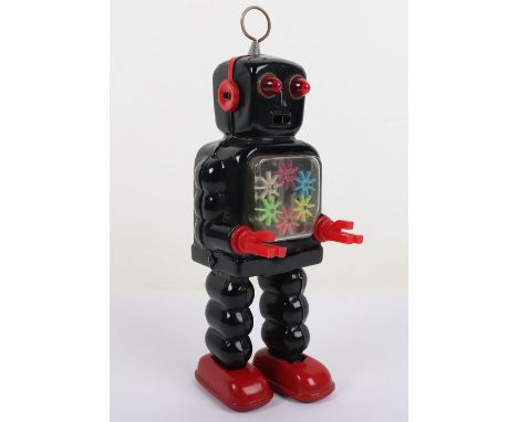 KO Yoshiya Clockwork High-Wheel Robot, Japanese 1950s, black tinplate robot with red plastic pincers, transparent gear action