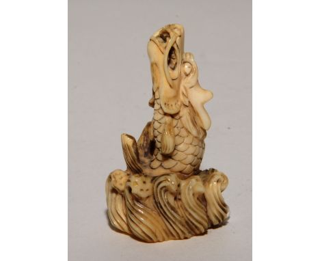 A Japanese carved ivory Netsuke, in the form of a sea dragon, signed to underside, 5cm high  CONDITION REPORT: Lot 245 - Circ