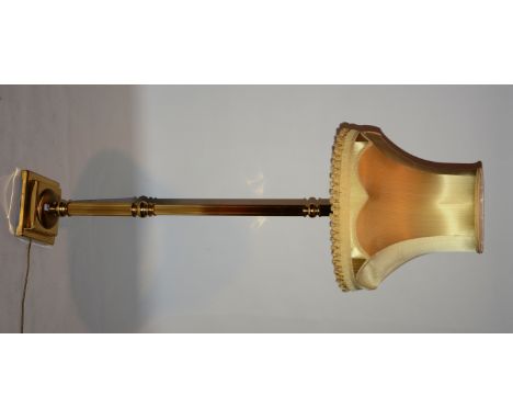 A brass Corinthian style floor lamp with shade, terminating on square foot, 168cm high