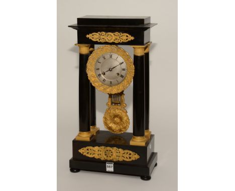 An 18th century French ebonised and ormolu Portico clock signed Leroy A Paris, with Corinthian style pillars, ormolu spandrel