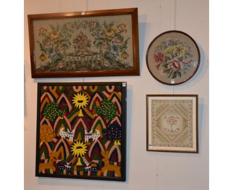 A tapestry made by the Indians of Guatemala, colourfully decorated with deer, cats and peacocks, 72 x 69cm, together with thr