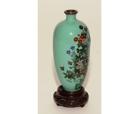 A small Japanese green cloisonne enamel vase from the Meiji period circa 1900, decorated with red and blue enamel floral pane