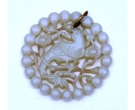 A Chinese white jade disc pendant, with pierced carved decoration depicting bird in foliage, 5.5cm CONDITION REPORT: Lot 252 