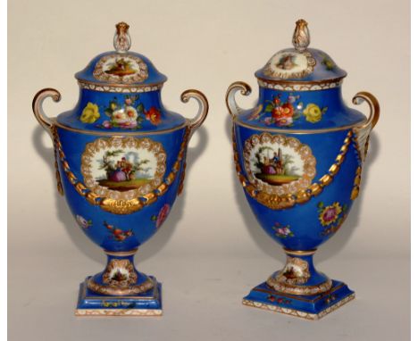 A pair of late 19th century Dresden porcelain urns and covers by Augustus Rex, decorated with panels of figures and hyacinth 