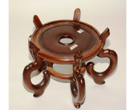 A Chinese Tielimu vase stand, the circular top raised on five scroll supports, 32cm diameter