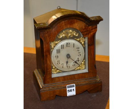 A late 19th/early 20th century walnut Black Forest mantel clock, the silvered dial with Arabic numerals and gilt metal spendr