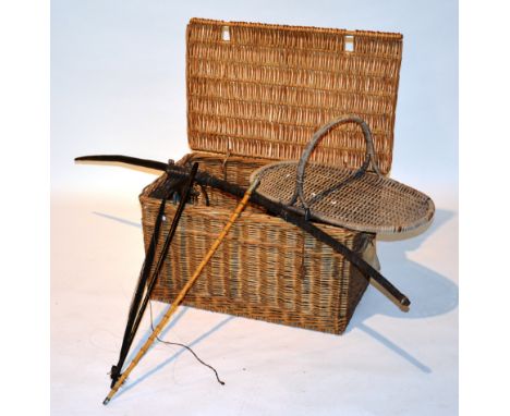 A mixed lot of collectables in wicker hamper, to include a vintage African bow, music bow and a military bamboo swagger stick