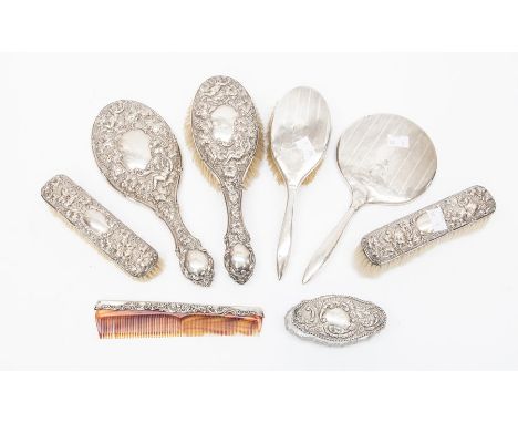 An Edwardian silver mounted dressing table set comprising of: a pair of clothes brushes; hair brush; mirror and comb, Birming