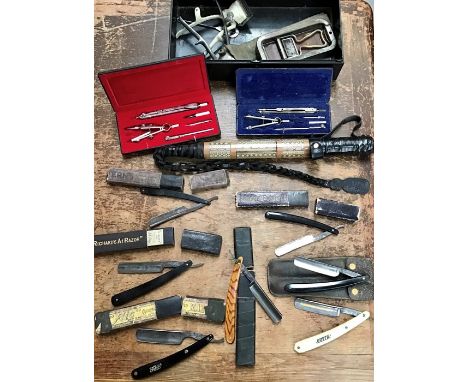 A riding crop with a metal first aid tin containing cut throat razors, hand operated hair clippers and geometry sets.