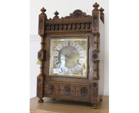 A Victorian oak cased mantle clock, brass face roman numerals, the case carved with baluster rail and rosettes (1)