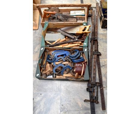 A collection of wood-working tools, including saws, carpentry, clamps etc, three wood planes, rip saw, three long clamps, plu