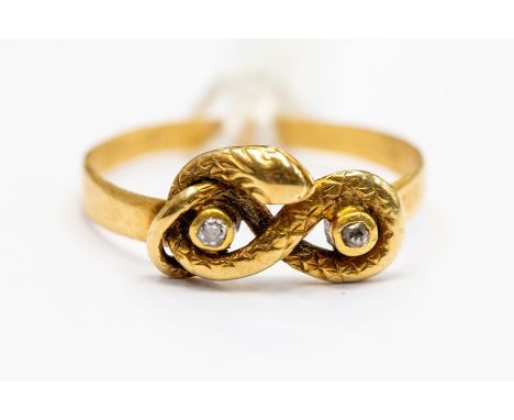 A Victorian diamond set serpent ring, the serpent coiled to the front with two inset diamonds, unmarked yellow metal assessed