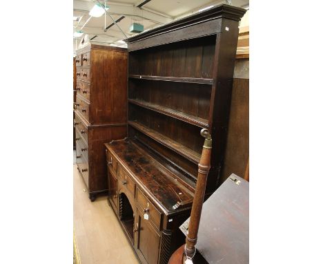 A mid 19th century oak dresser, moulded cornice above an enclosed three tier plate racks, on a rectangular sideboard fitted w