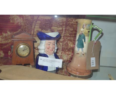 A Royal Doulton Dickens ware Mr Micawber jug together with an early 20th century oak clock and a Wood and Sons Toby jug