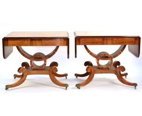 A Pair of Reproduction Sofa Tables, in Regency style, each with rounded drop leaves above two real and two sham drawers, rais