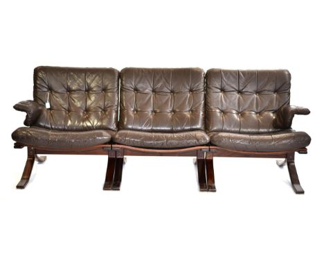 A 1970s Danish Leather Brown Three Seater Sofa, with buttoned cushions and arms, raised on square form legs, 206cm by 75cm by