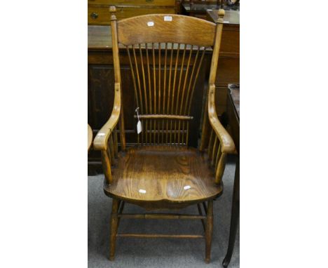 A 19th century oak and elm armchair with waisted stick back 