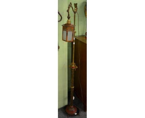 An Oriental brass standard lamp, the stem decorated with dragons, blossoms and character symbols 