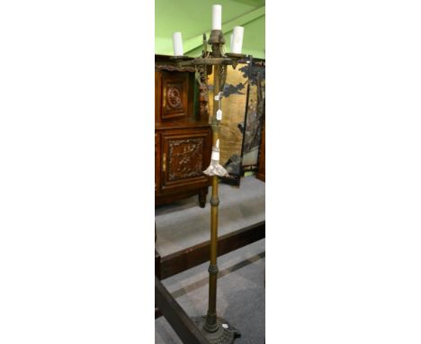 A bronze standard lamp, circa 1900, with scroll supports, knopped column and circular base, 173cm high, converted to electric