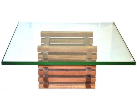 A Glass Top Coffee Table, of recent date, of square form and raised on a wooden sectional base made of interlocking wooden bl