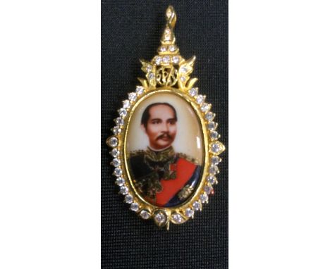 A gold coloured pendant, tests at 14k, with portrait of King of Siam Thailand Chulalongkorn, surround by CZ stones, 9g 