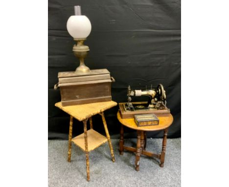 Singer Sewing Machine;  bamboo occasional table'  oak folding table;  oil lamp (4) 