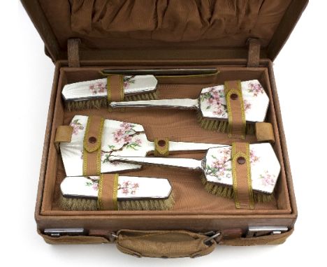 A plated and enamel six-piece dressing table set with floral and butterfly decoration, in a leather case (damages)