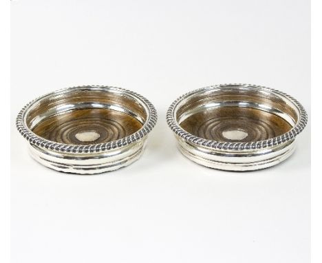 A pair of William IV silver wine coasters, Henry Wilkinson & Co, Sheffield 1833, with gadrooned rims, 15cm diameter    Condit