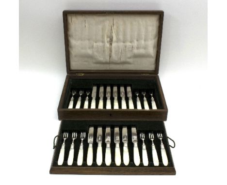 A set of mother-of-pearl handled silver dessert knives and forks, Sheffield 1915, twelve settings, in a fitted canteen